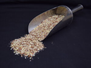 a scoop with organic macadamia nut bird supplement